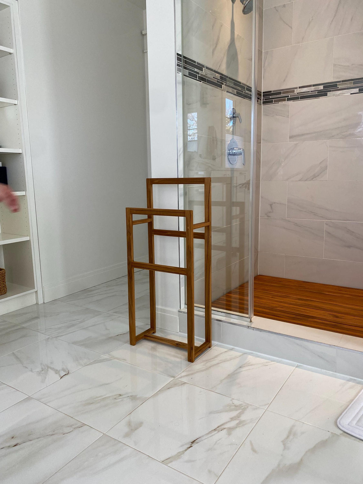 Solid teak towel rack mounted on a bathroom wall side view