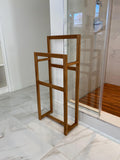 Solid teak towel rack mounted on a bathroom wall