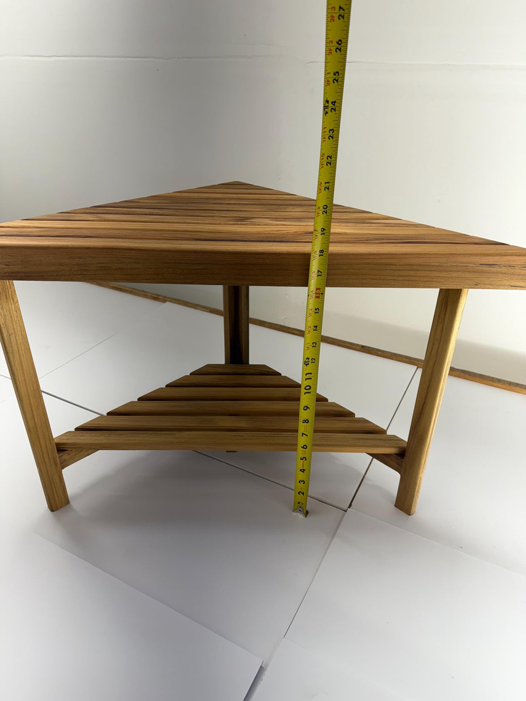 Teak corner bench built into a bathroom shower showing height of 18 inches