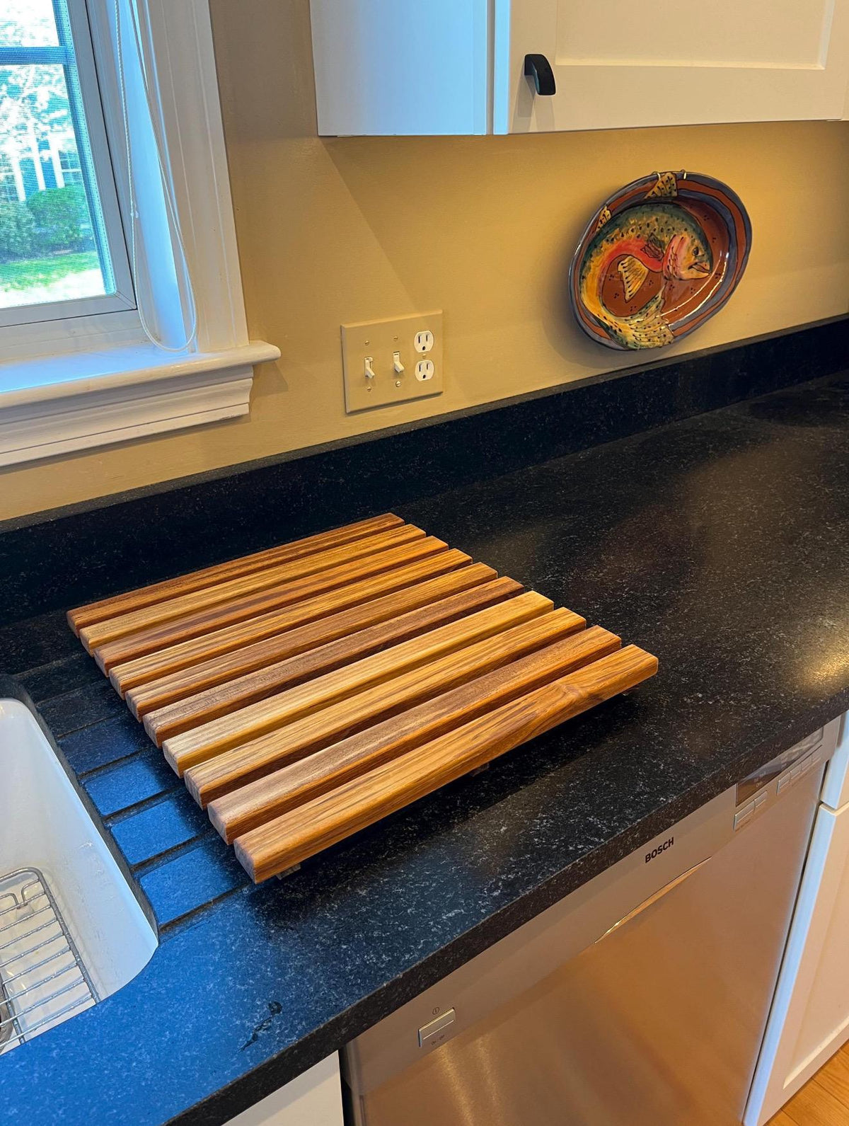Teak dish drying rack on counter