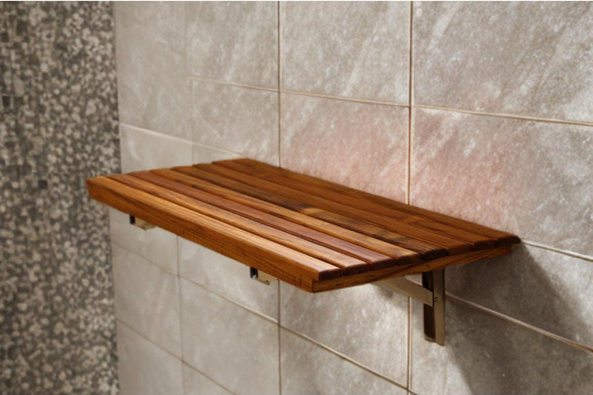Wall-mounted teak folding shower bench in the down position