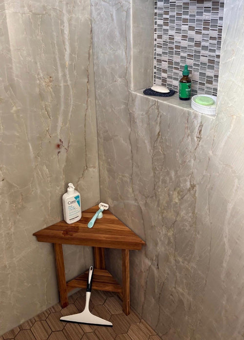 Solid teak corner bench installed in a walk-in shower