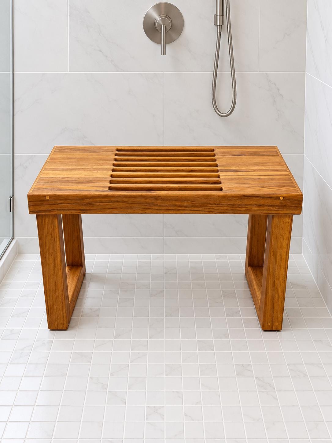 A Freestanding Teak Shower bench in a white tiled shower